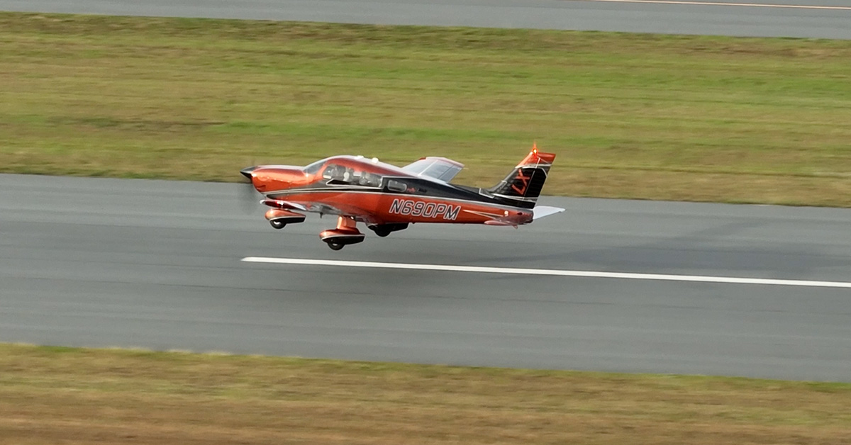 Piper Archer aircraft taking off at small rural airport during flight instruction
