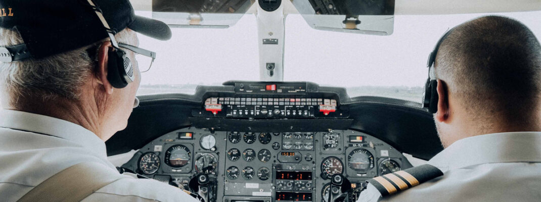 two pilots in cockpit flying