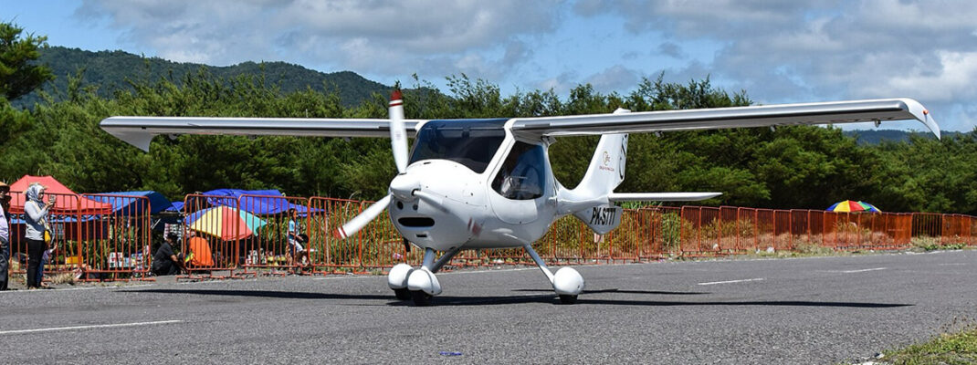 Light-sport fixed-wing aircraft performing landing during competition or flight training.