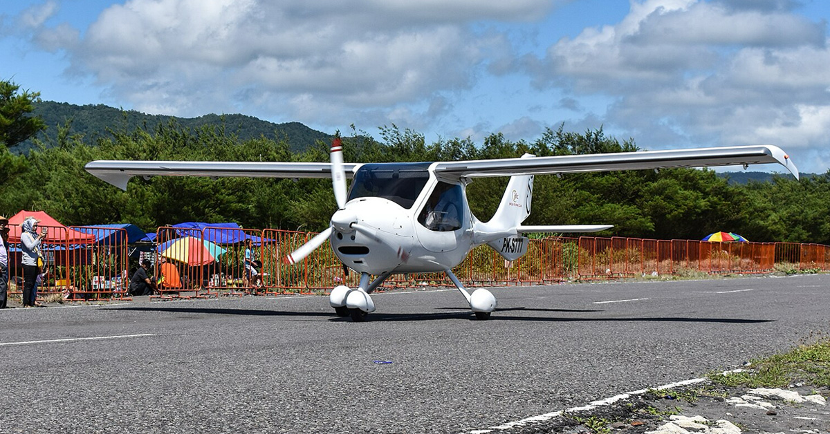 Light-sport fixed-wing aircraft performing landing during competition or flight training.