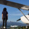 Photo of woman standing on airfield with small-engine planes