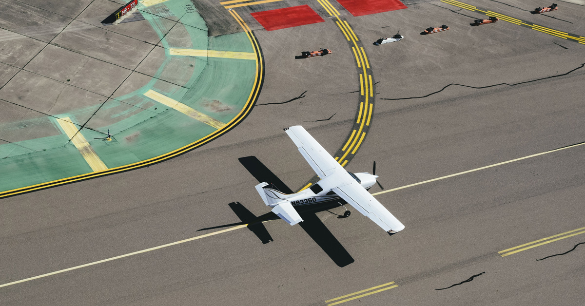overhead photo of white plane of runway