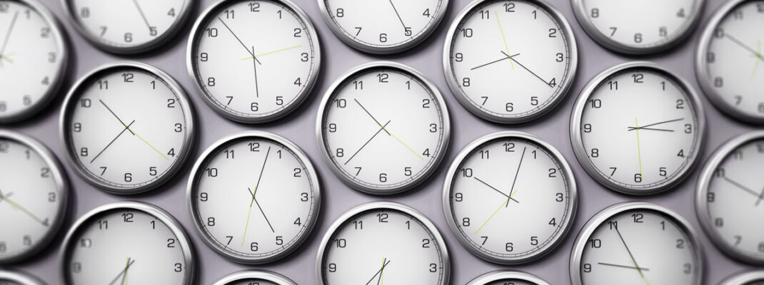 wall of identical clocks set at different times