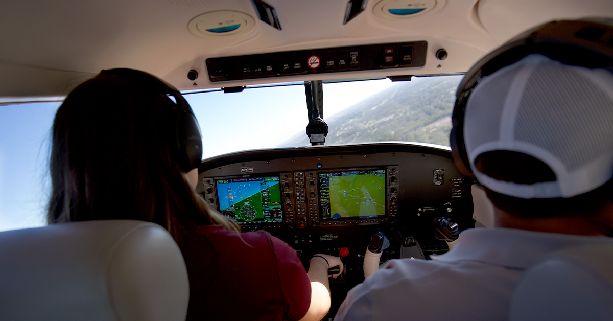 Photo from inside cockpit of student pilot and CFI during steep turn