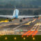 commercial airplane on a lighted runway during takeoff