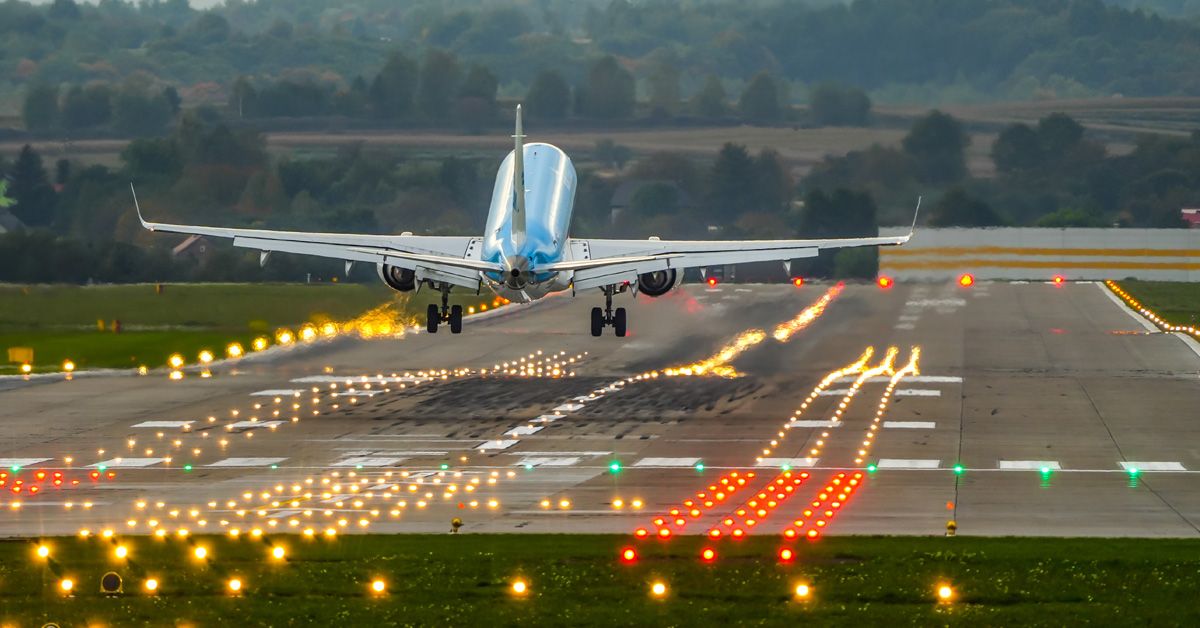 commercial airplane on a lighted runway during takeoff