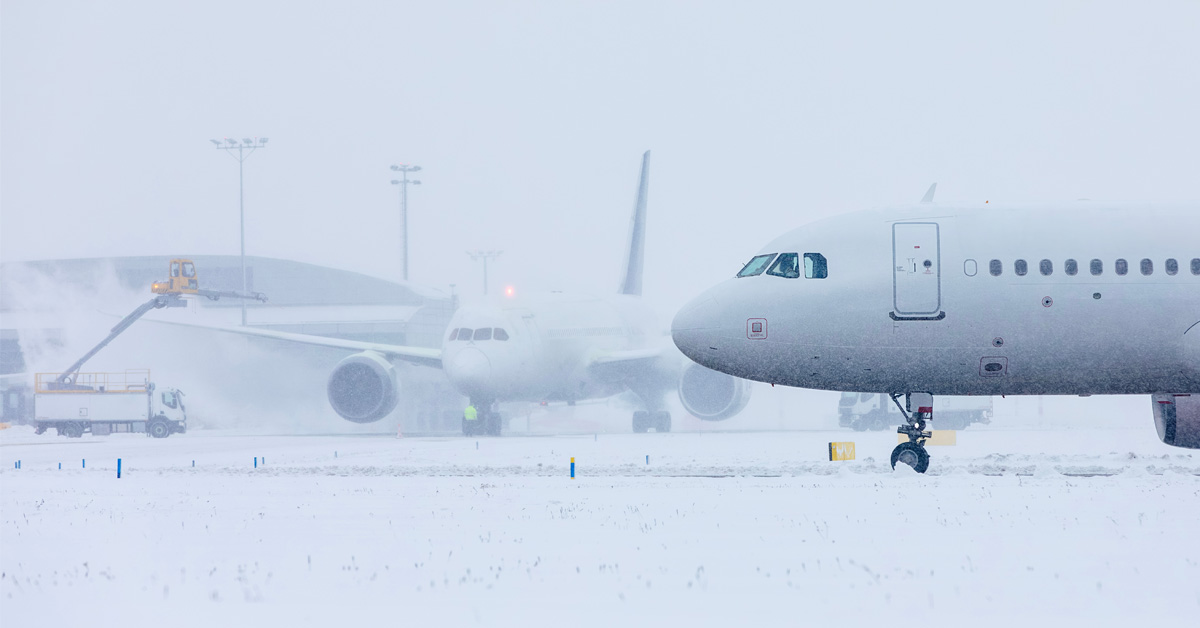 two planes and deicing on a snowy day