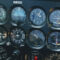Detailed view of an aircraft cockpit showcasing various control meters and technology.
