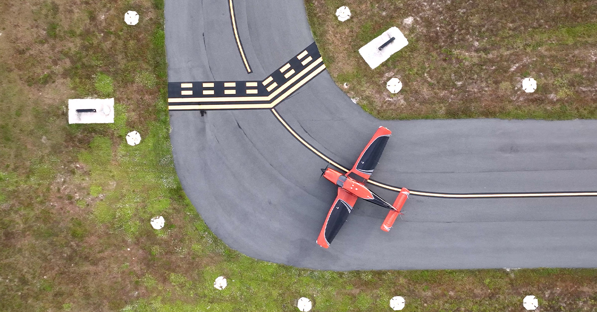 Aerial view of Piper Archer aircraft on taxiing at small rural airport