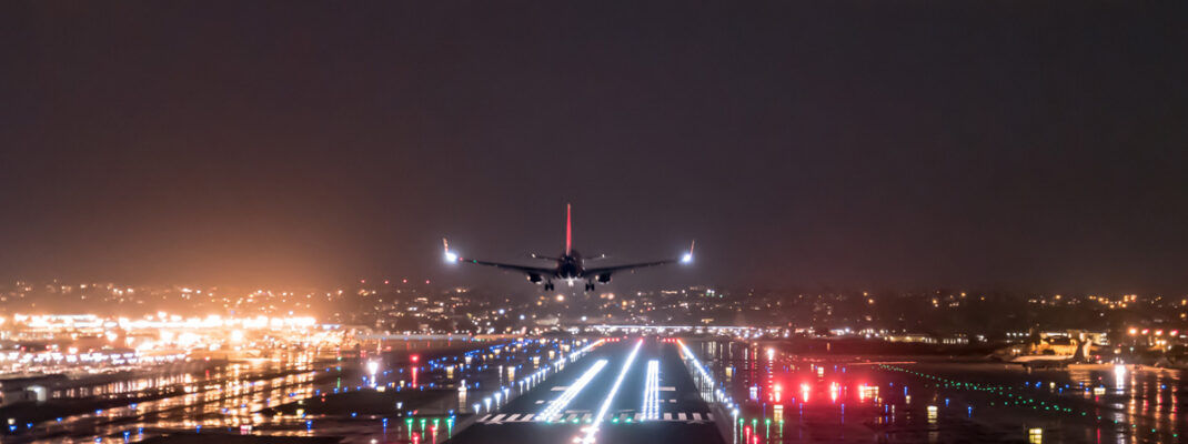 airplane landing at night with runway lights prominent