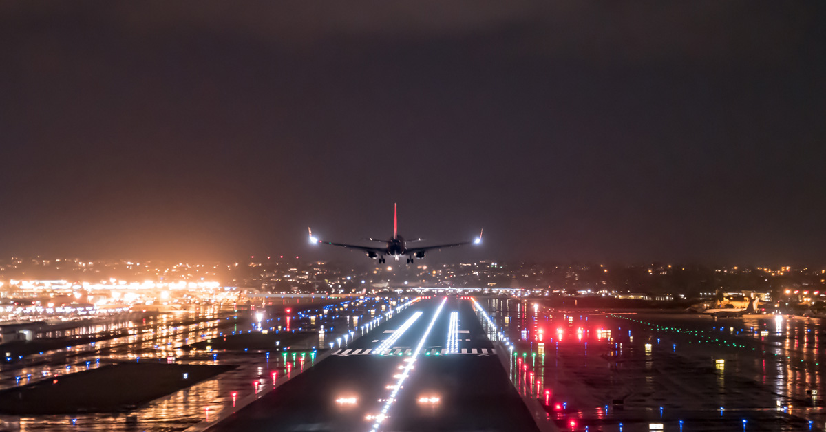 airplane landing at night with runway lights prominent