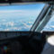 Pilot in a commercial airliner airplane flight cockpit during flight with great weather