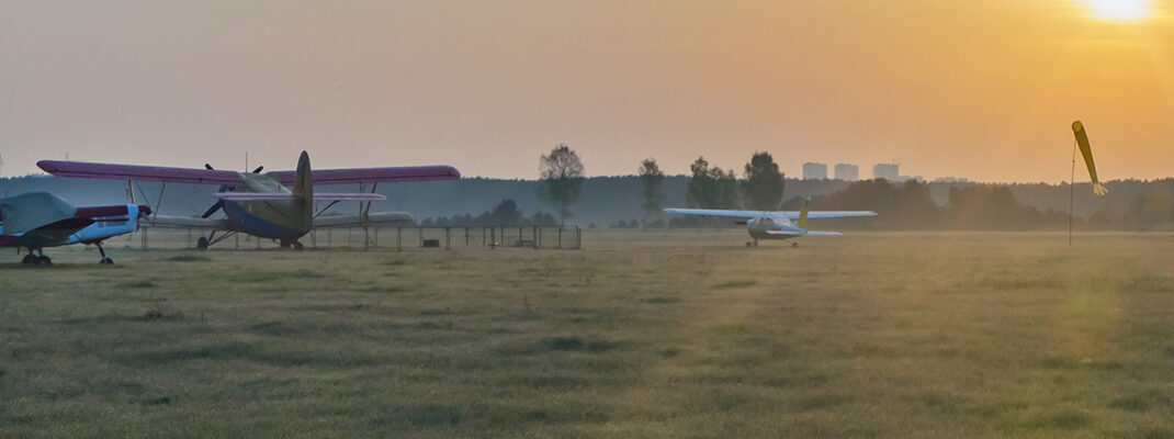 Morning dew on the aerodrome with small aircraft at dawn