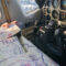 Pilot navigating while reading sectional chart in cockpit