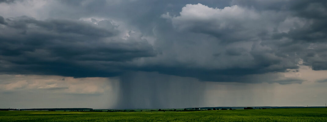 Thunderstorm front in landscape with dark sky with rain clouds before storm.