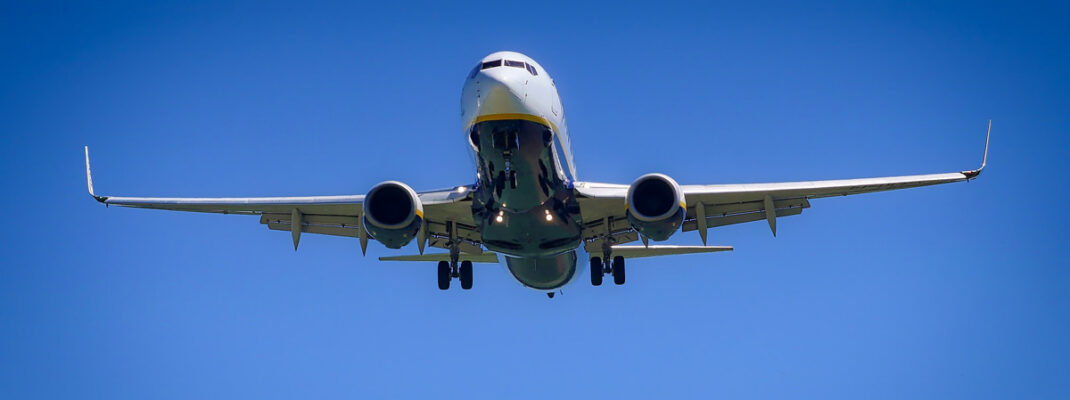 commercial airplane in flight wit deep blue sky background