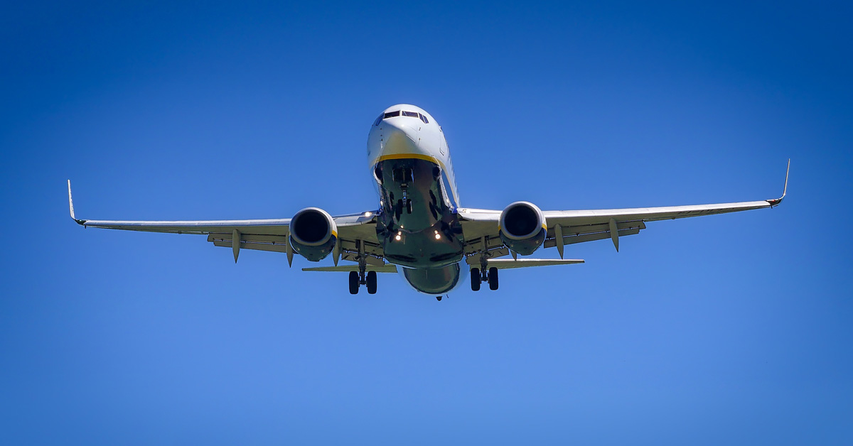 commercial airplane in flight wit deep blue sky background