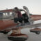 Female student pilot preparing for solo flight by performing checkride in Piper Archer airplane. Loading and checking back seats.