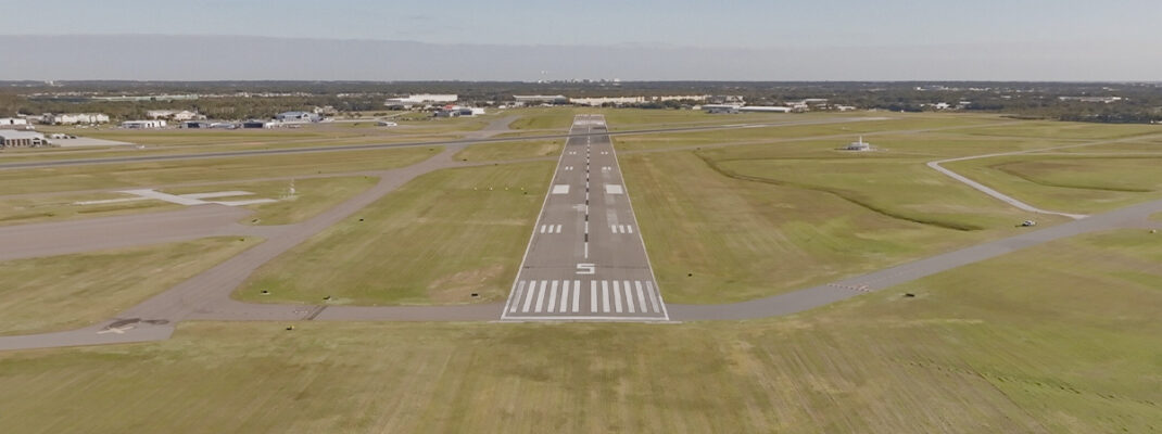 Small rural airfield seen from sky at low altitude upon normal landing