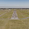Small rural airfield seen from sky at low altitude upon normal landing