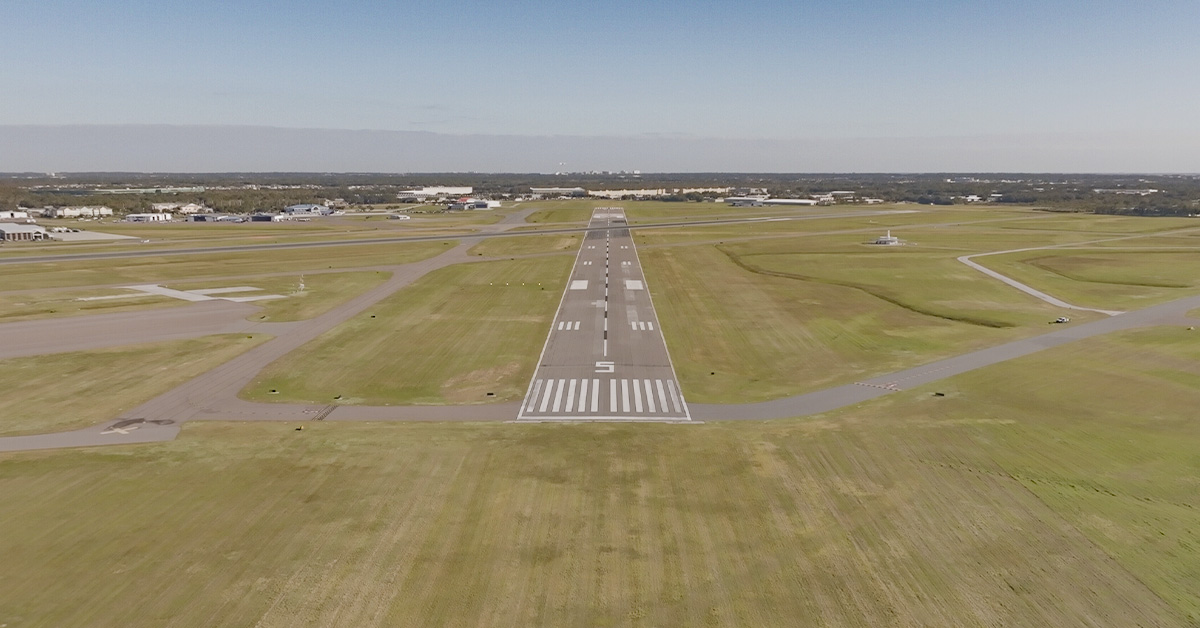 Small rural airfield seen from sky at low altitude upon normal landing
