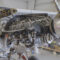 Small aircraft engine exposed in maintenance hanger to display cooling and other components
