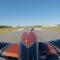 Piper aircraft landing on taxiway at small rural airfield