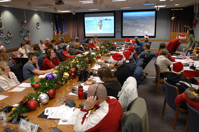 room full of NORAD volunteers helping track Santa.