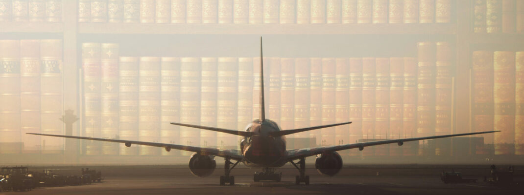 Airplane at airport during sunrise with law books overlayed