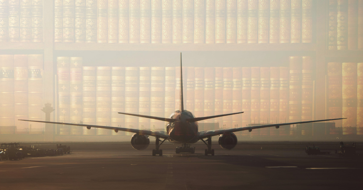 Airplane at airport during sunrise with law books overlayed