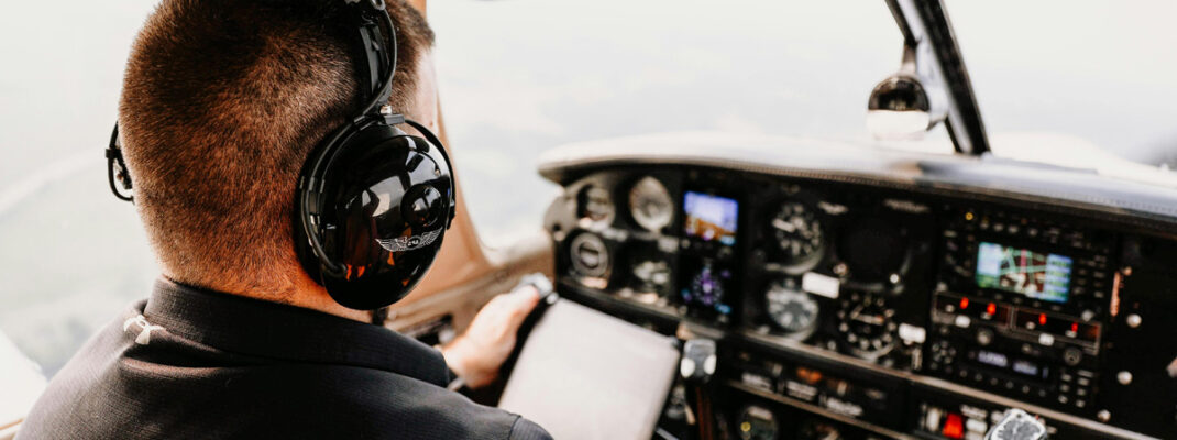 Man in Cockpit Wearing Headphones