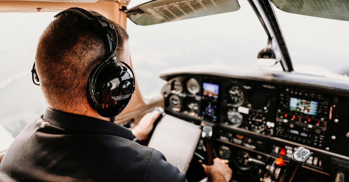 Man in Cockpit Wearing Headphones